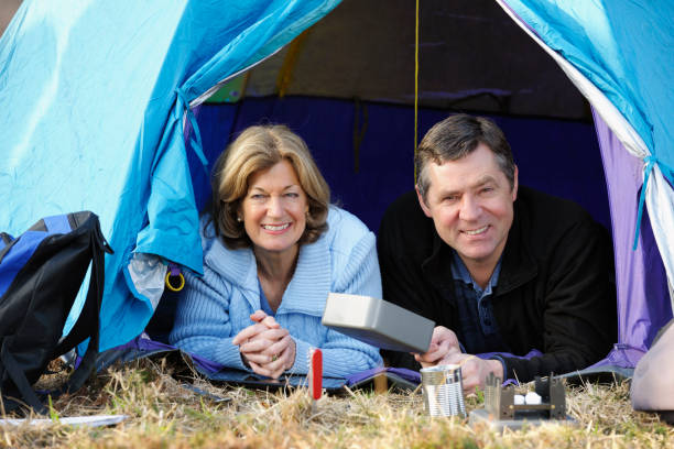 Mature Couple In A Tent A portrait a mature couple in atent. ashdown forest photos stock pictures, royalty-free photos & images