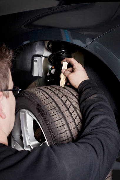 istock Mechanic is checking the skid depth of a tire 155372338