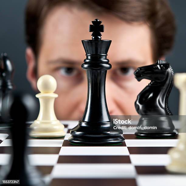 Selective Focus Mans Eyes On Chess Pieces Stock Photo - Download Image Now - Chess, Human Face, Leisure Games
