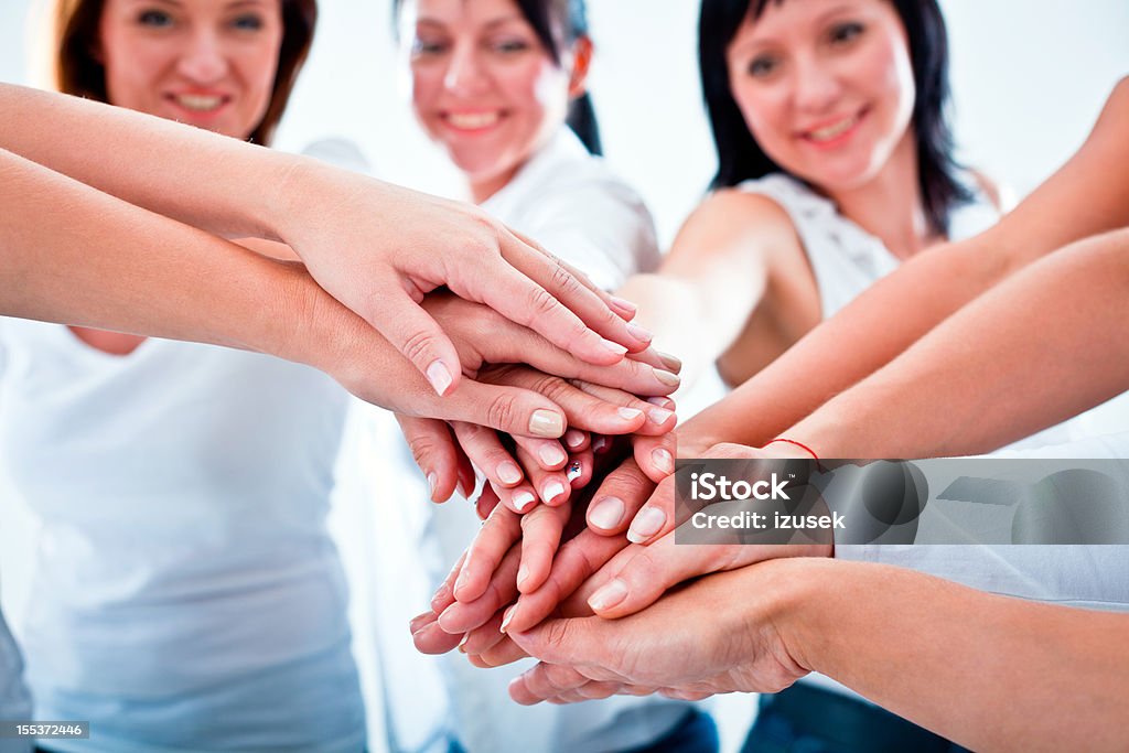 Helping hands Teamwork concept. Women putting their hands on top of eatch other. A Helping Hand Stock Photo