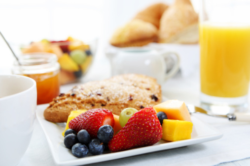 Table full of various fresh food in luxury modern restaurant. Delicious dishes, cold cuts, salmon, omelette, pastries, juices, cheese. Delicious and lavish breakfast or morning meal in high-end hotel