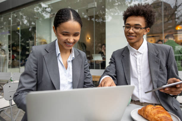 istock Business partners discussing something and working on laptop together 1553724600