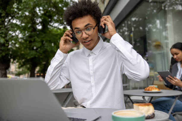 istock Young businessman with headphones working remotely and looking contented 1553725126
