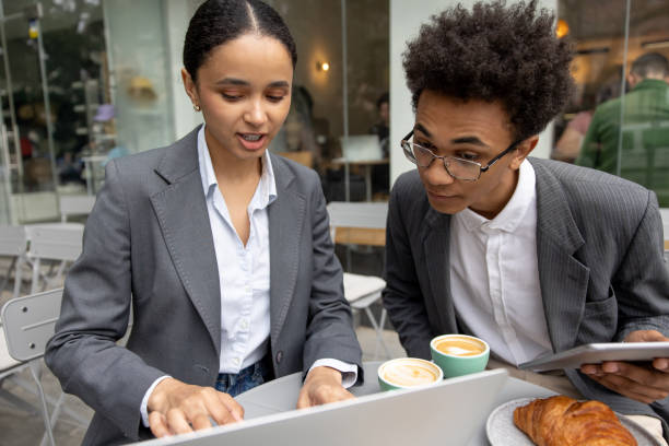 istock Business partners discussing something and working on laptop together 1553725147