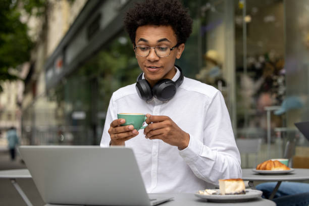 istock Young businessman having a video call and having morning coffee 1553725158