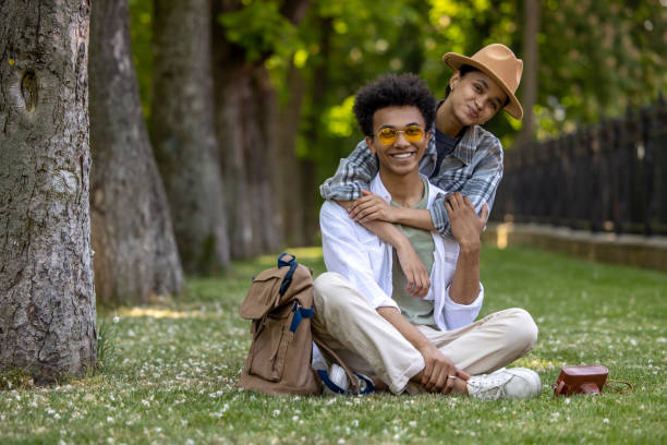 istock Young couple looking happy while spending time together in the park 1553726294