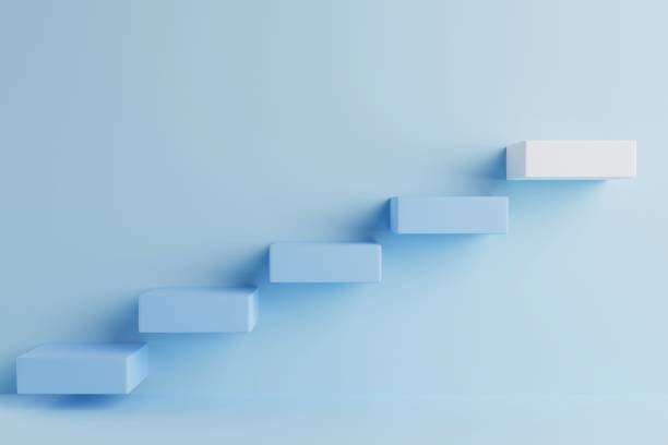 istock Empty room featuring a blue plastic ladder that leads up a stairway to success 1553726308