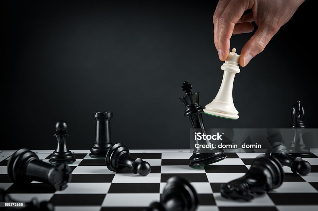 Checkmate strategy, Chess player or businessman making his checkmate move Chess player or businessman making his checkmate move. Checkmate Stock Photo