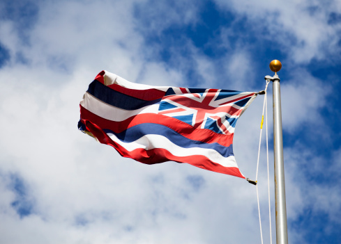 The flag of Hawaii flying in the breeze.