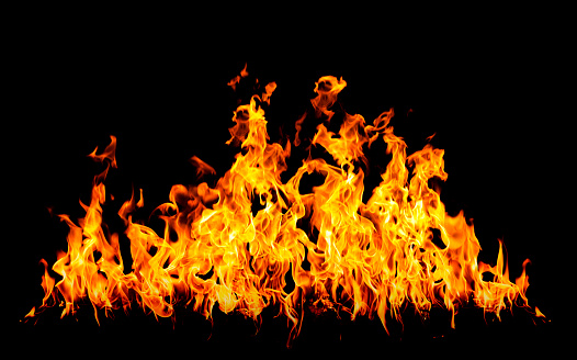 Raging flames of intense fire with no reflection over black background