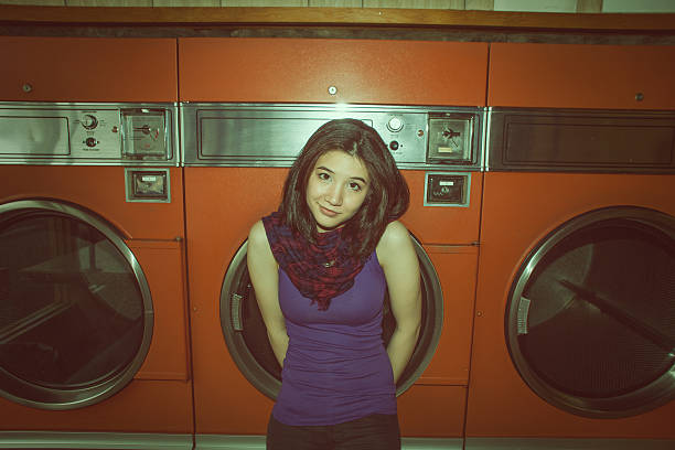 istock Young woman in a laundromat 155372866