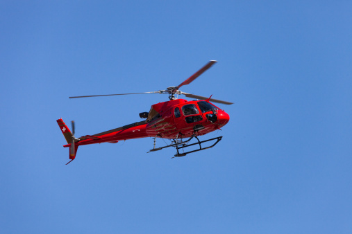 Swiss Helicopter in Flight with Clear Blue Sky