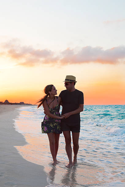istock Couple After Sunset Walking Along The Beach 155373167