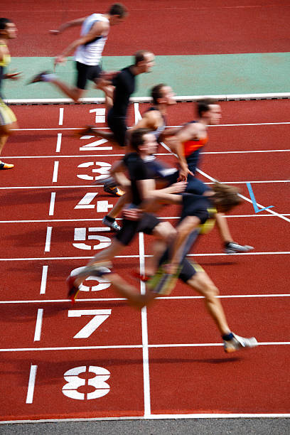 Photo finish of a track race Blured motion finish of a sprinting race. finish line photos stock pictures, royalty-free photos & images