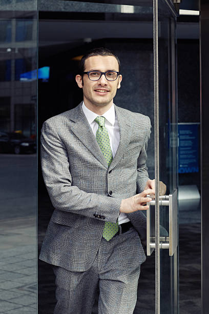 istock Businessman walking through glass door 155373240