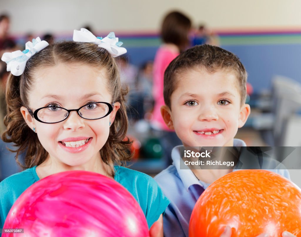 Children Bowlers A little girl and boy holding bowling balls.   Ten Pin Bowling Stock Photo