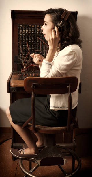 istock old cord switchboard operator, woman in chair  155374212