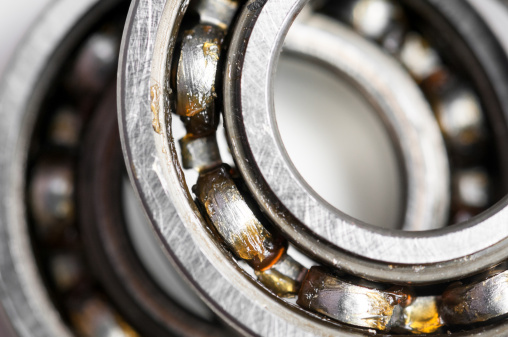 Closeup of a pair of bearing used in motor for home appliances. Top view on a white background.