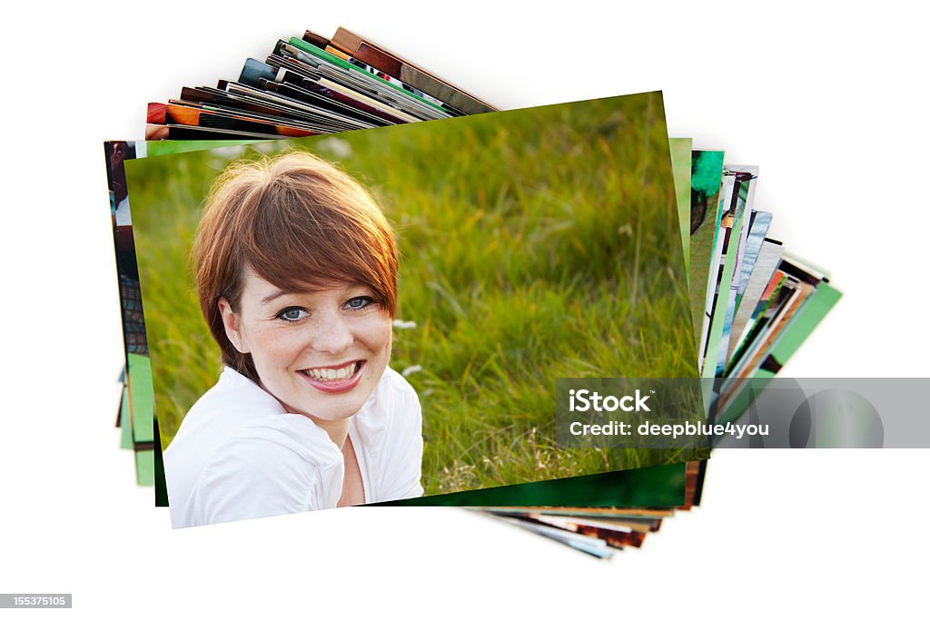 Stack of holiday photographs on white stack of paperphotographs on white background with a beauty smiling dark hair teenager on the first image Photograph Stock Photo