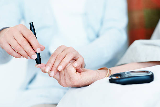Patient having blood sugar levels checked stock photo