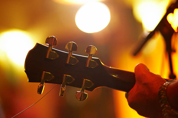 istock Man playing an acoustic guitar on stage 155375255
