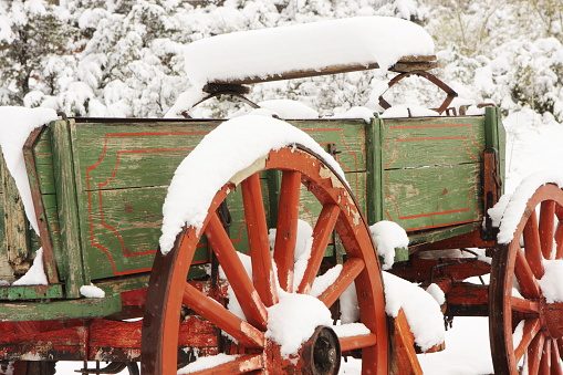 Antique carriage wagon with spoked wheels in winter snow.  Yavapai County, Arizona, 2012.