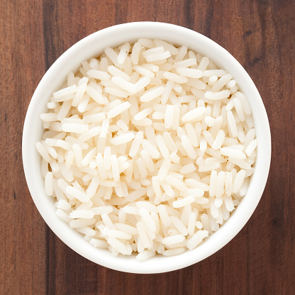 Top view of white bowl full of boiled white rice