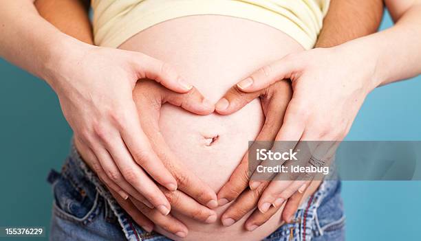 Pregnant Caucasian Woman And Hispanic Man Making Heart With Hands Stock Photo - Download Image Now