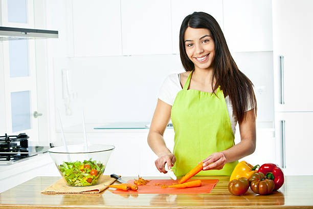 istock Young woman preparing a healthy salad 155376264