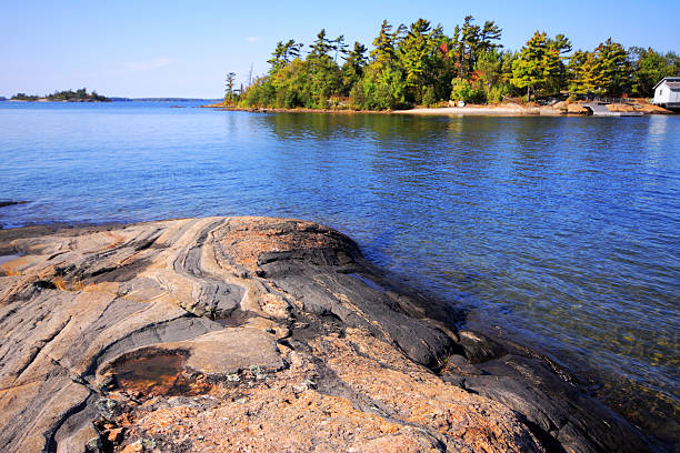 Cottage country in Ontario with metamorphic rock in the foreground