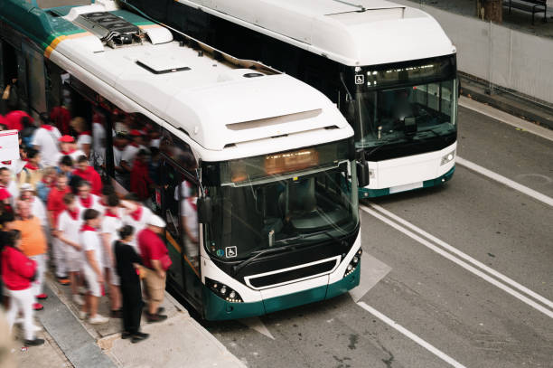 istock Crowd of people in motion entering a bus 1553765008