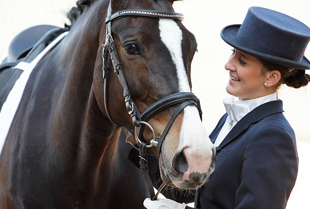 Dressage rider with her horse Portrait of a beautiful woman looking at her horse after a successful dressage competition. Canon Eos 1D MarkIII dressage stock pictures, royalty-free photos & images