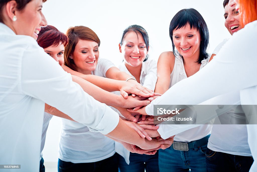Teamwork Teamwork concept. Group of smiling women joining hands.  Adult Stock Photo
