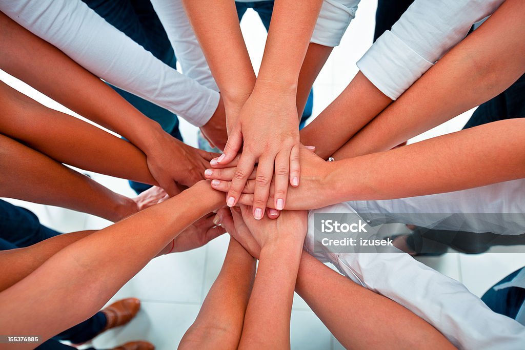 Teamwork Teamwork concept. Group of women joining hands. Elevated view. Adult Stock Photo