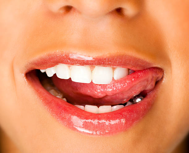 istock Girl Licking Lips With Glossy Lipstick 155377018