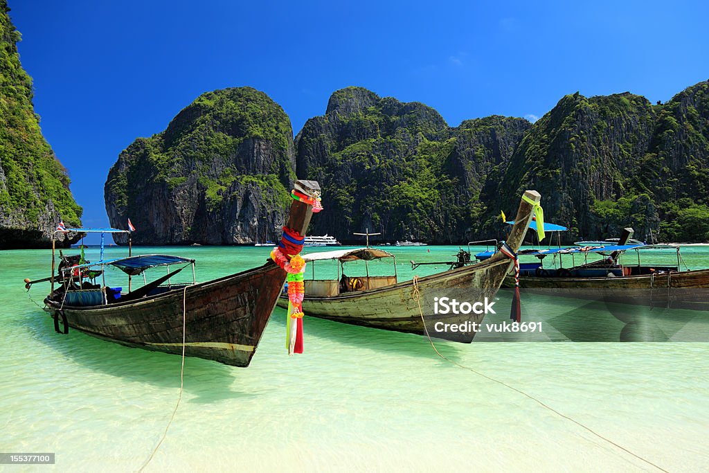 Beautiful Maya bay Long tail wooden boats moored at Maya Bay-Phi Phi Islands-Thailand Thailand Stock Photo