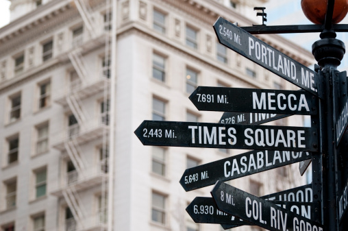 Directional and distance signs in Pioneer Courthouse Square in Portland, Oregon. Signs point to Mecca, Times Square, Casablanca, and Portland (Maine).