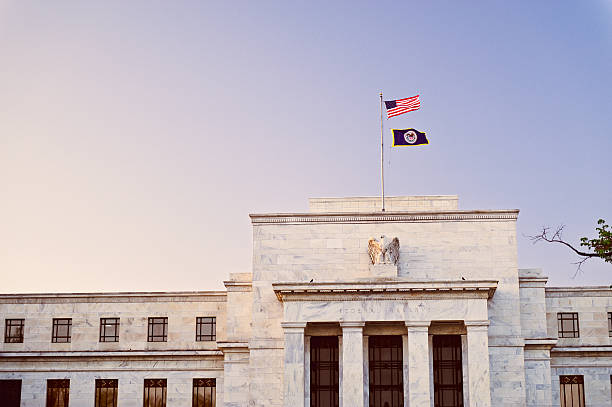 Federal Reserve building at sunset with US flag on top stock photo