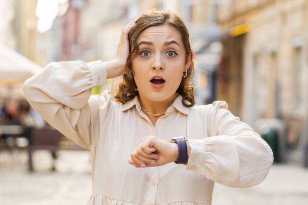Free Stock Photo of Young woman checking the time in urban setting ...