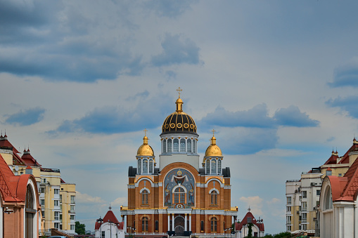 Sviato-Pokrovskyi (Holy Virgin Protection) Cathedral. Wide-angle landscape view of Church of the Intercession at Obolon neighborhood in Kyiv, Ukraine. Blue sky background.