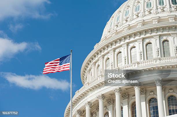 American Flag Waving In Front Of Capitol Hill Stock Photo - Download Image Now - Capitol Building - Washington DC, Washington DC, Capitol Hill