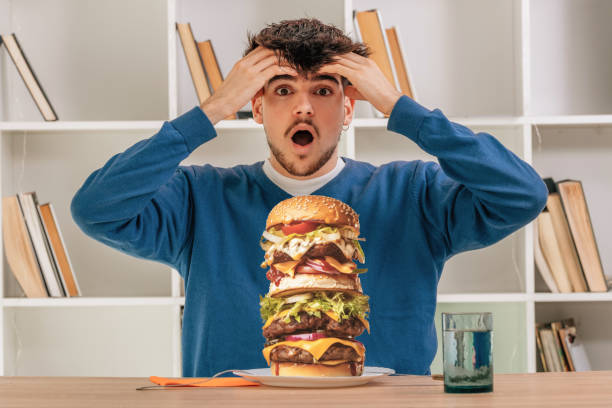 istock boy eating hamburger, fast food 1553778940