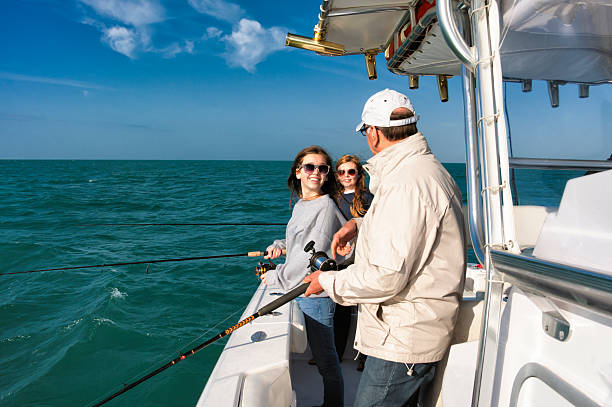 multi geração família real em um barco de pesca. - fishing active seniors family senior adult imagens e fotografias de stock