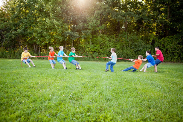 istock Happy Young Boys Playing Tug-of-War Outside 155378086