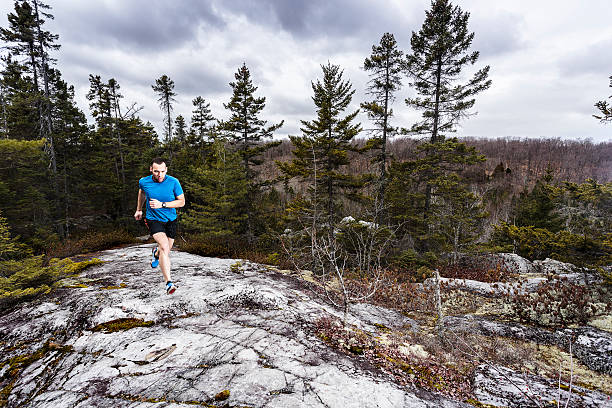 A runner sprinting the trail up in the hills  stock photo