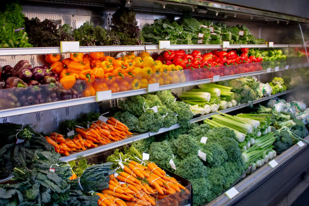 fresh vegetable display A view of a fresh vegetable display at a local grocery store. pile of carrots stock pictures, royalty-free photos & images