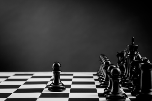 Leader. Black Chess Pawn on chess board in black and white.
