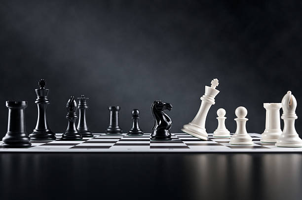 Checkmate move, Chess Knight is checking Chess King, chess board stock photo
