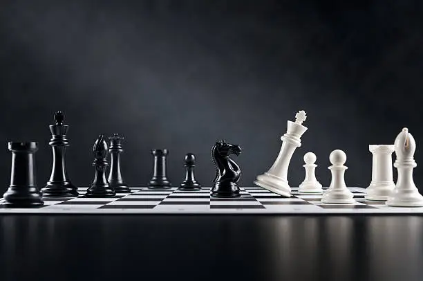 Photo of Checkmate move, Chess Knight is checking Chess King, chess board