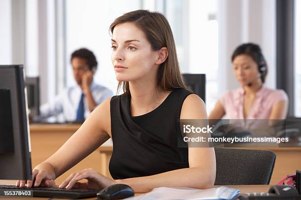 Female Worker In Busy Office On Desktop Computer Stock Photo - Download Image Now - Adult, Business, Business Person